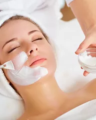 applying skin peal treatment to a woman's face