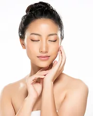 woman with closed eyes touching her face
