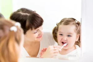 Photo of baby brushing teeth