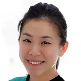 Young Asian woman smiling warmly in teal scrubs