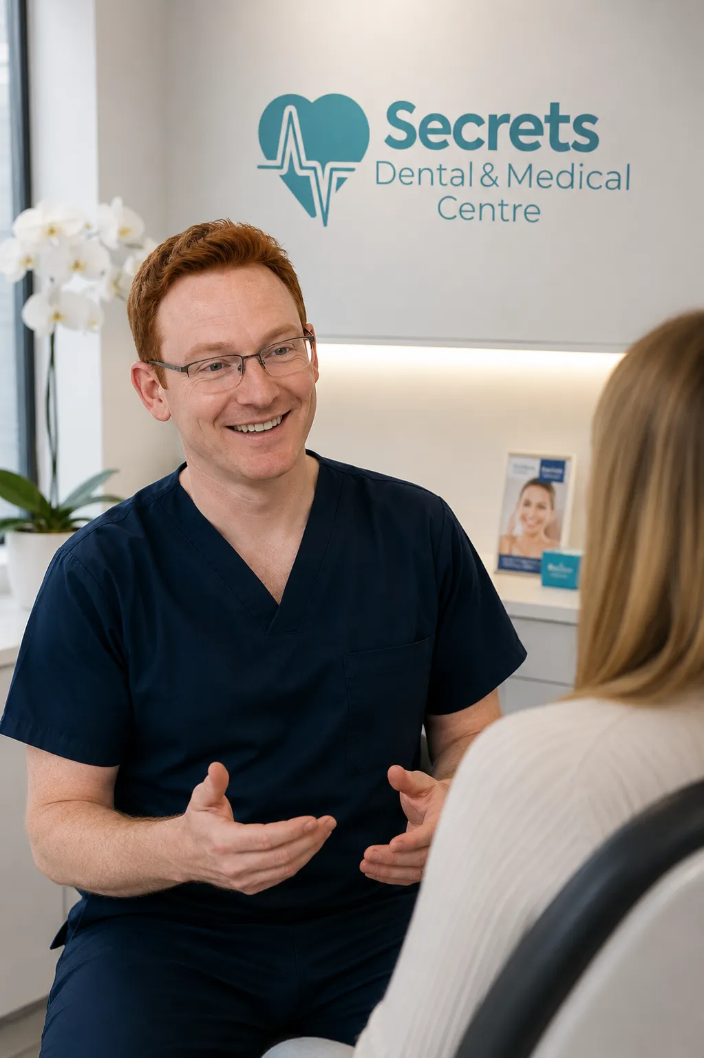 Smiling dentist consulting with patient at Secrets Dental Centre